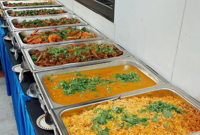 Indian dishes arranged along a buffet line